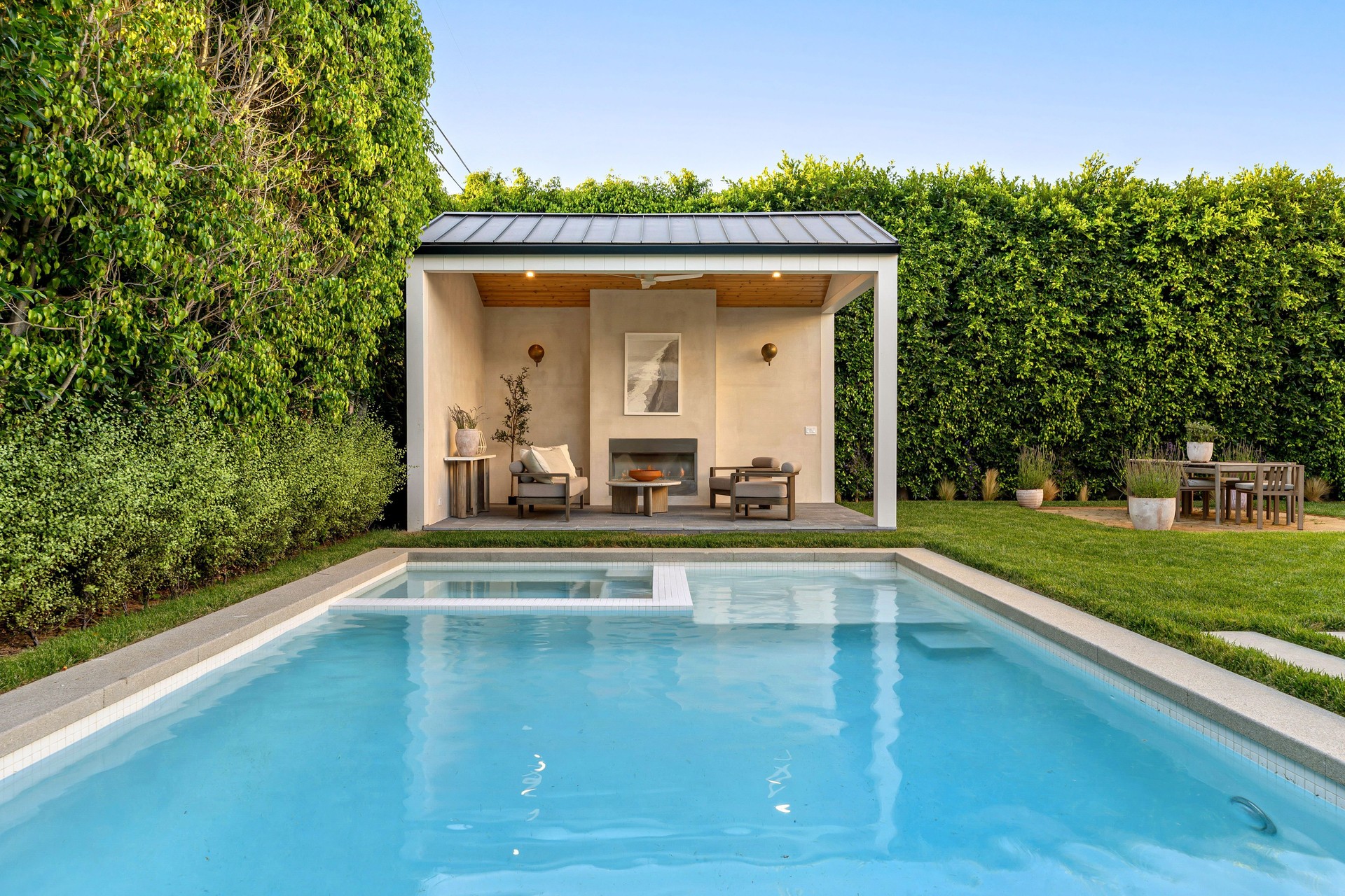 Modern backyard with pool and patio.