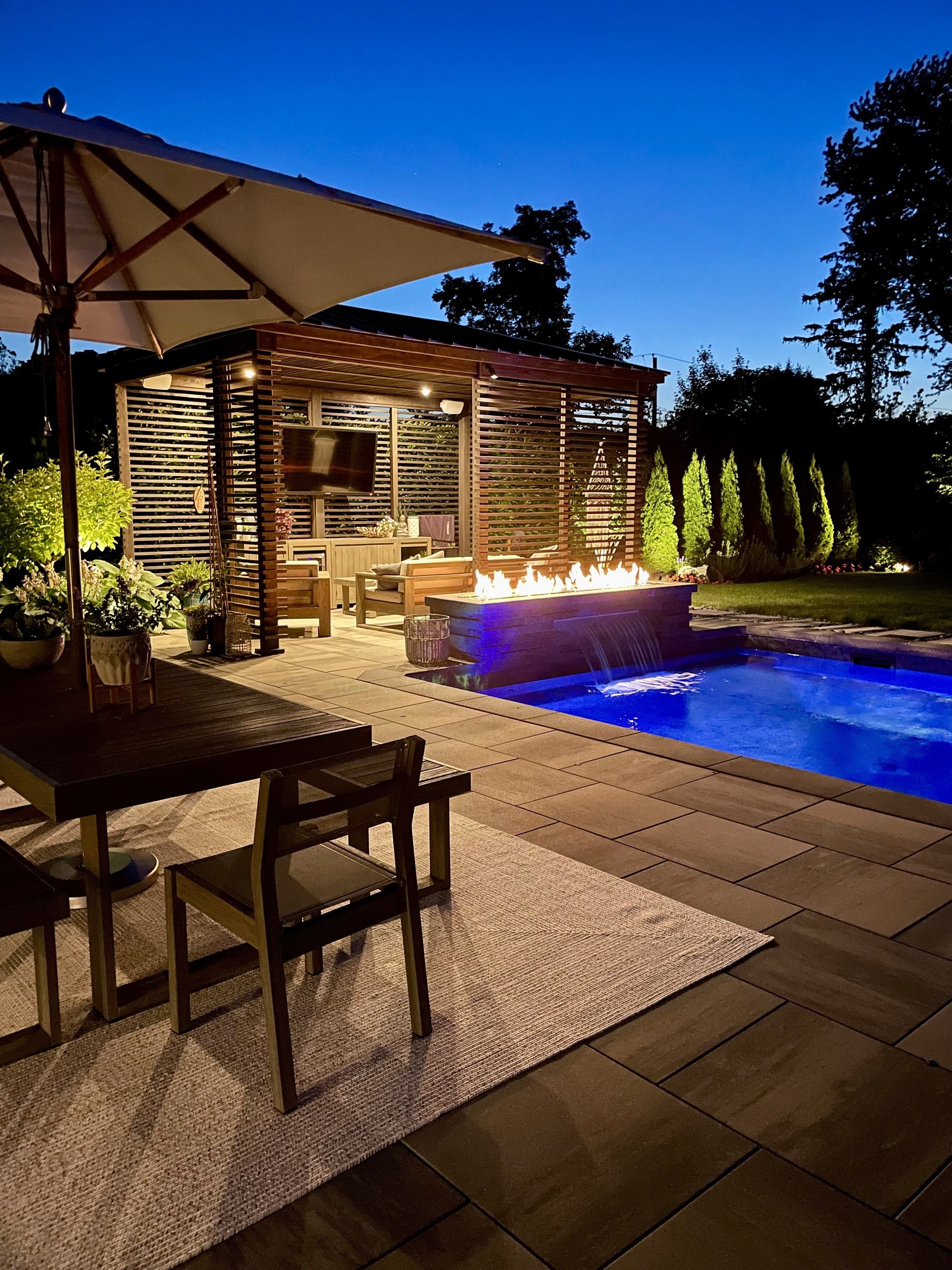 Gorgeous modern backyard at night, perfect lighting design and aesthetics